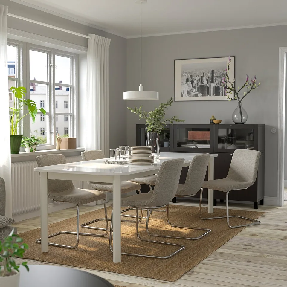 Modern dining room with STRANDTORP table, chairs, and large windows.