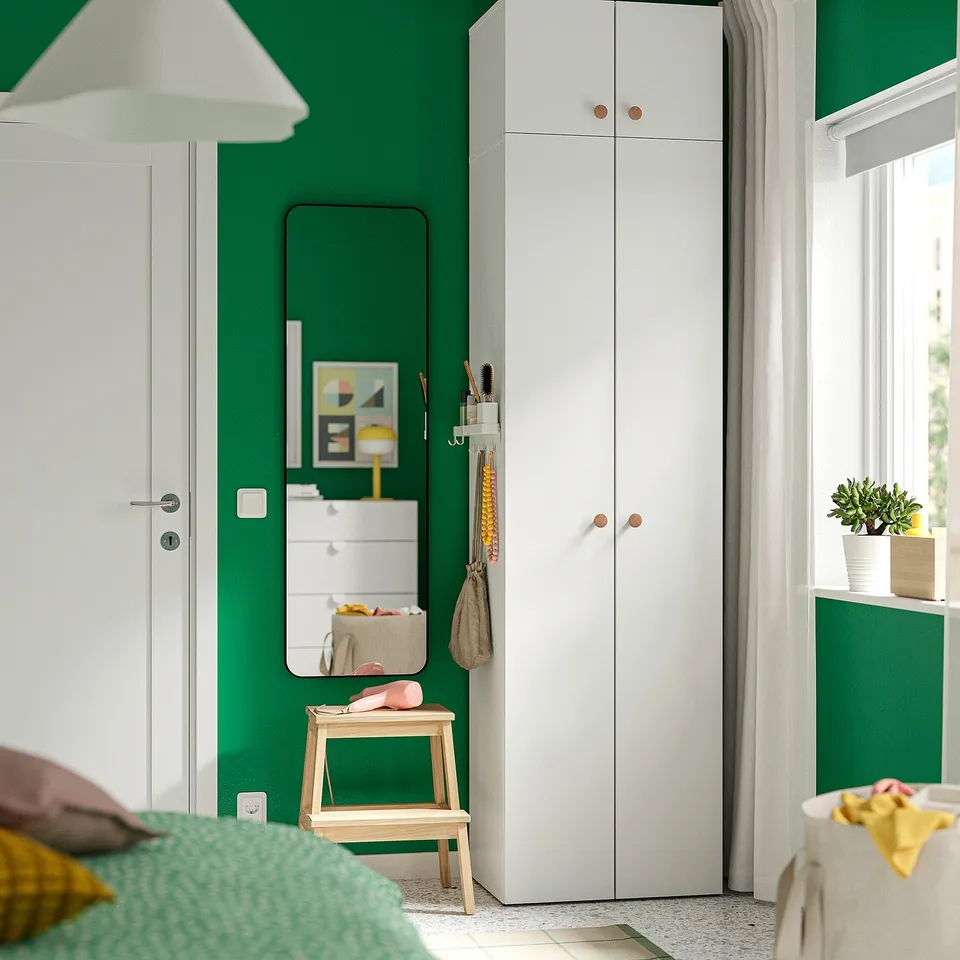 Modern kids room with white LASTARE wardrobe, green wall, window, mirror, stool, lamp, plants, colours.