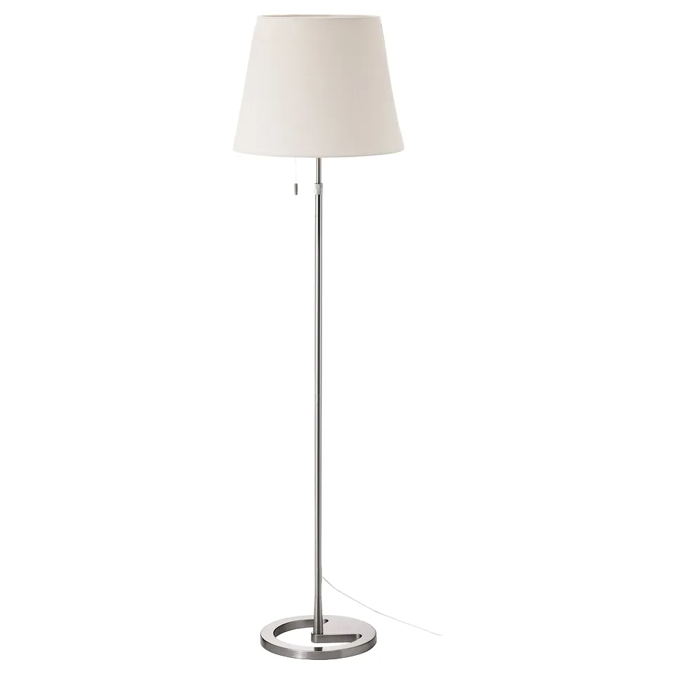 The NYFORS lamp a white textile shade atop a nickel-plated, adjustable silver metal stand, offering versatile lighting.