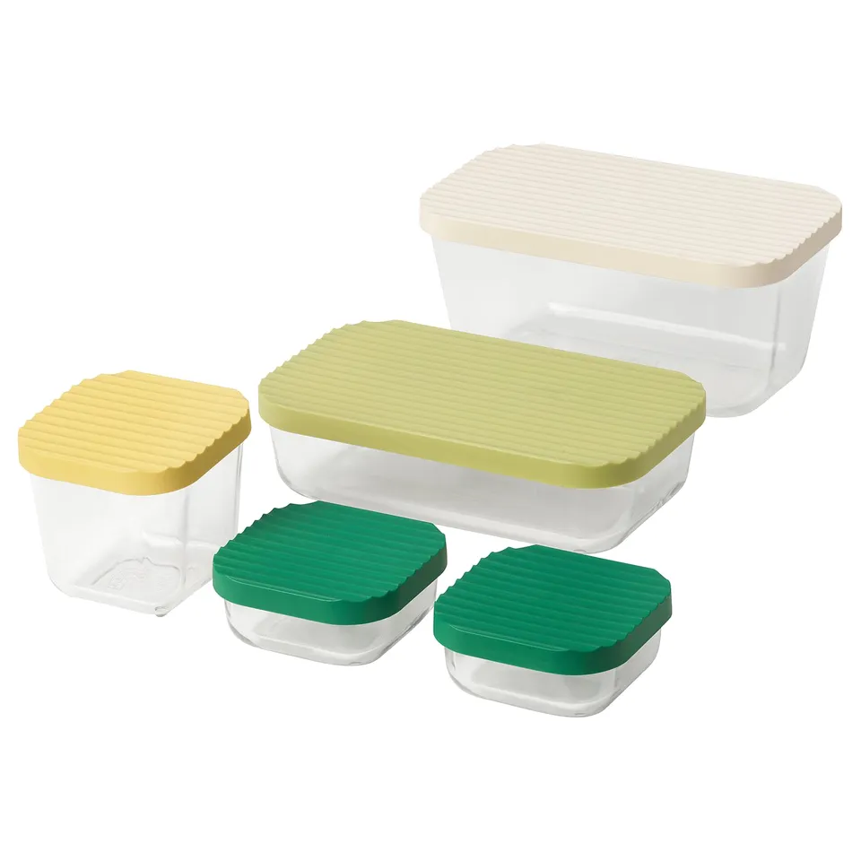 Set of colourful plastic-lidded glass food storage containers in various sizes.