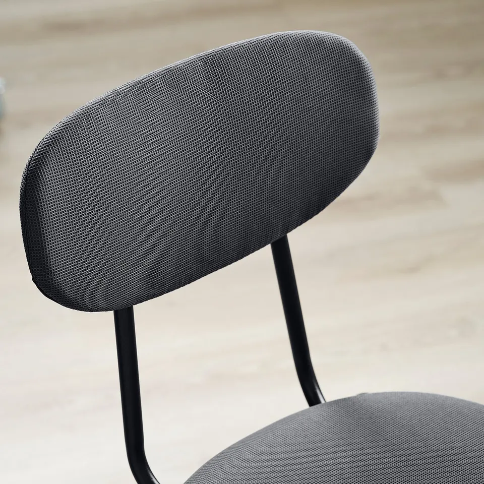 Chair backrest detail: soft, upholstered cushion with sturdy metal frame.