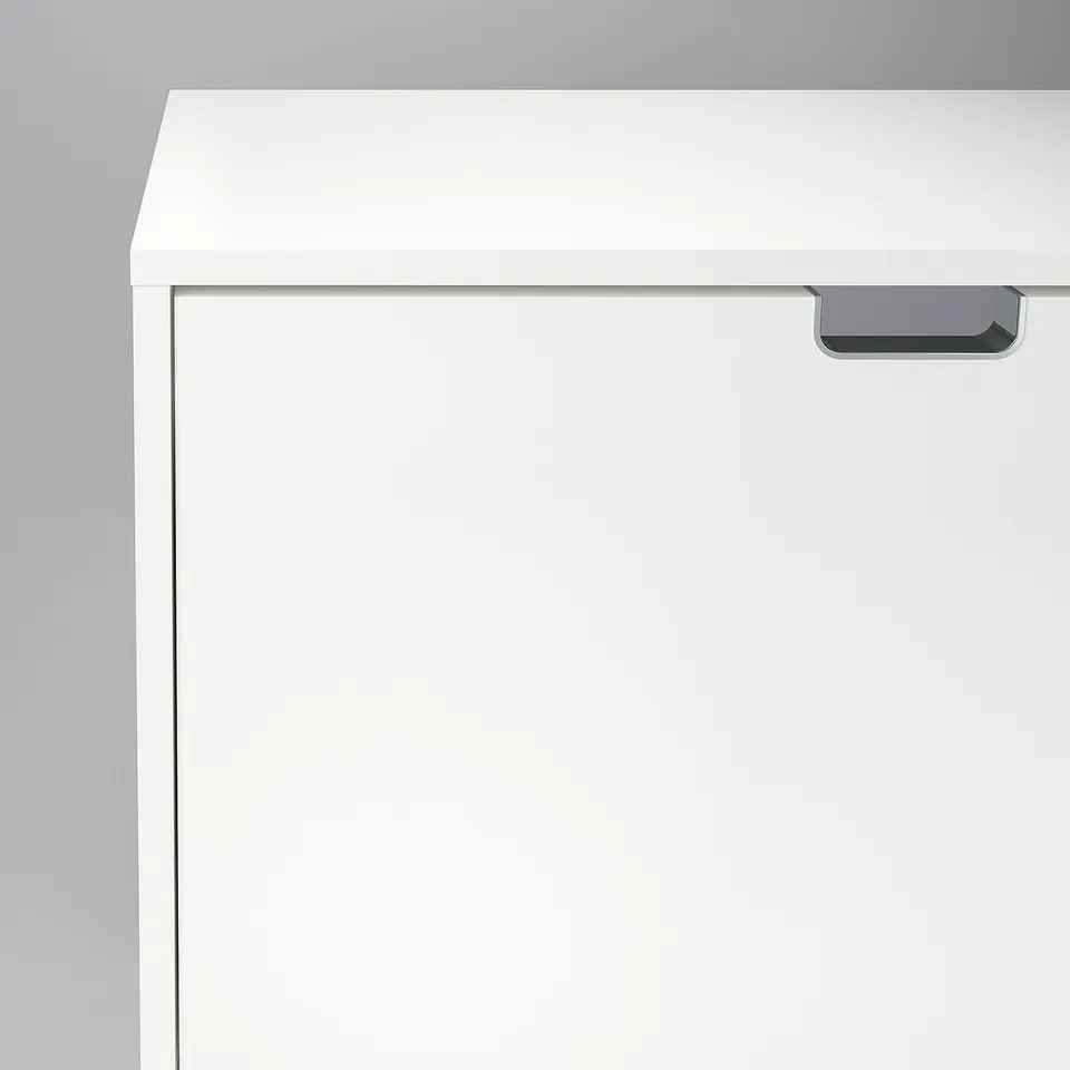 A sleek white STÄLL shoe cabinet featuring sturdy handles and a smooth finish, designed for durability and functionality.