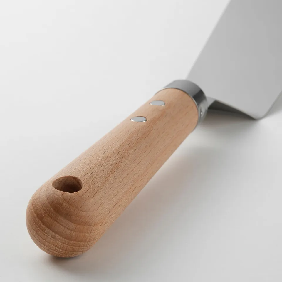 Wooden-handled spatula, durable and stylish, with a hanging hole for easy storage. Curved edge for precise food flipping and serving.
