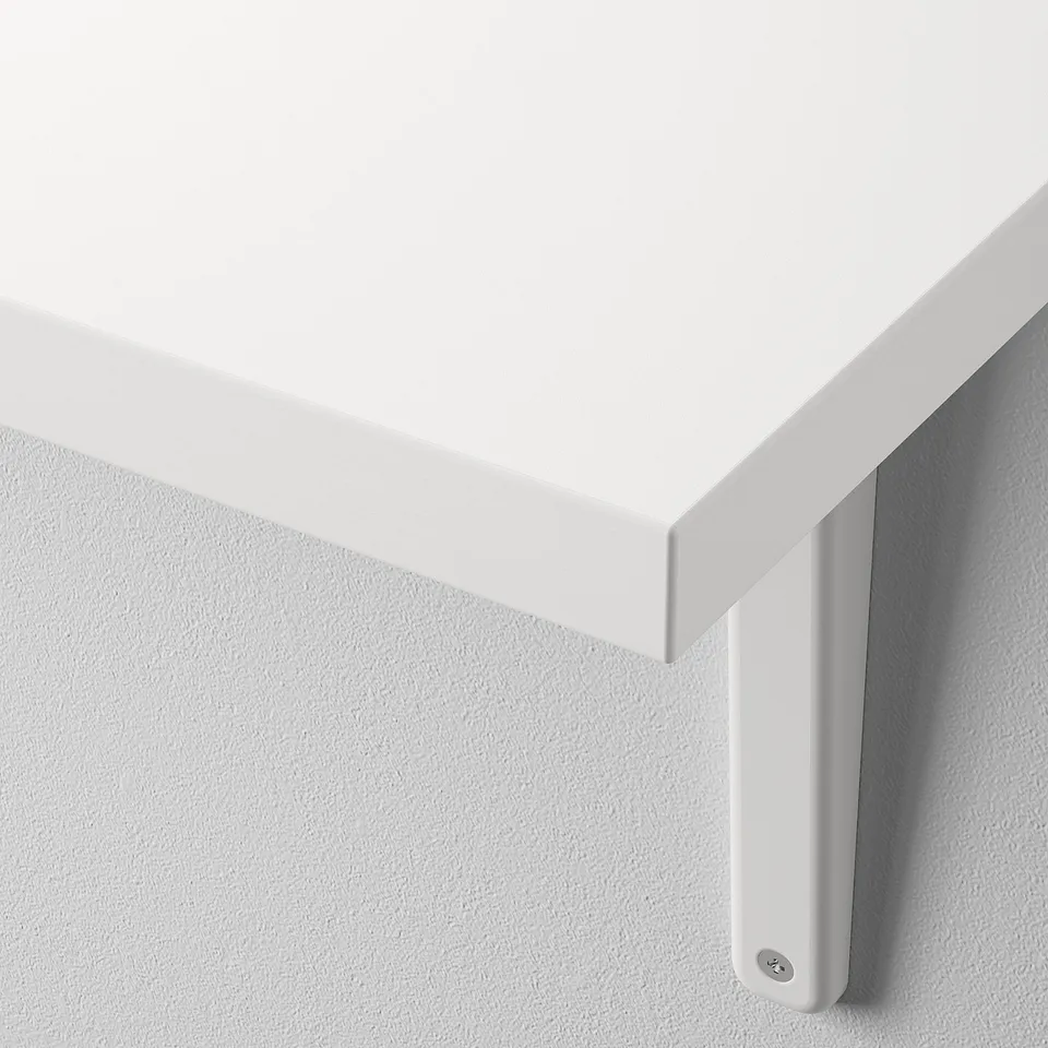 Clean, modern white wall shelf with a bevelled edge. Mounted securely on light grey wall.