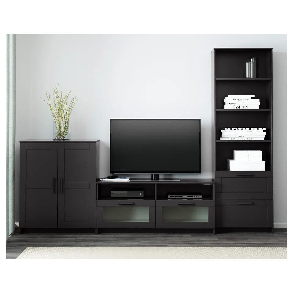 Modern living room with adjustable tv stand, glass-doored cabinets, and decor.