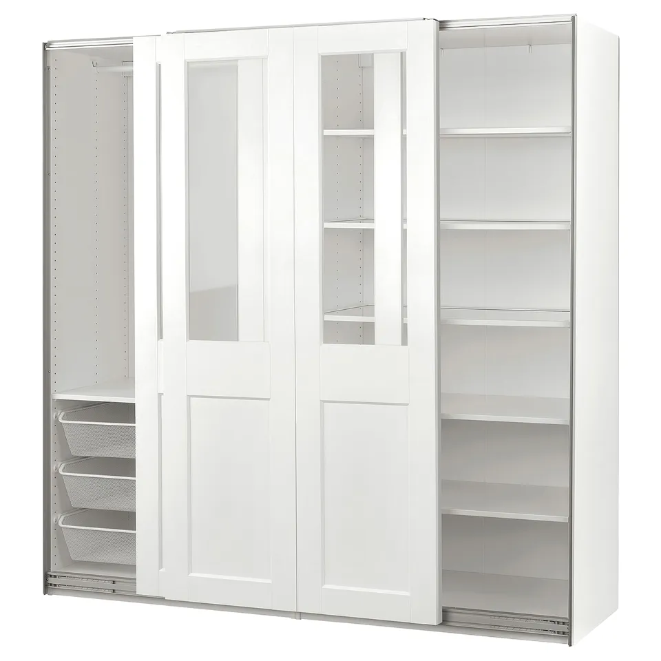 A white PAX wardrobe with clear glass doors, featuring open shelves and organisers inside.