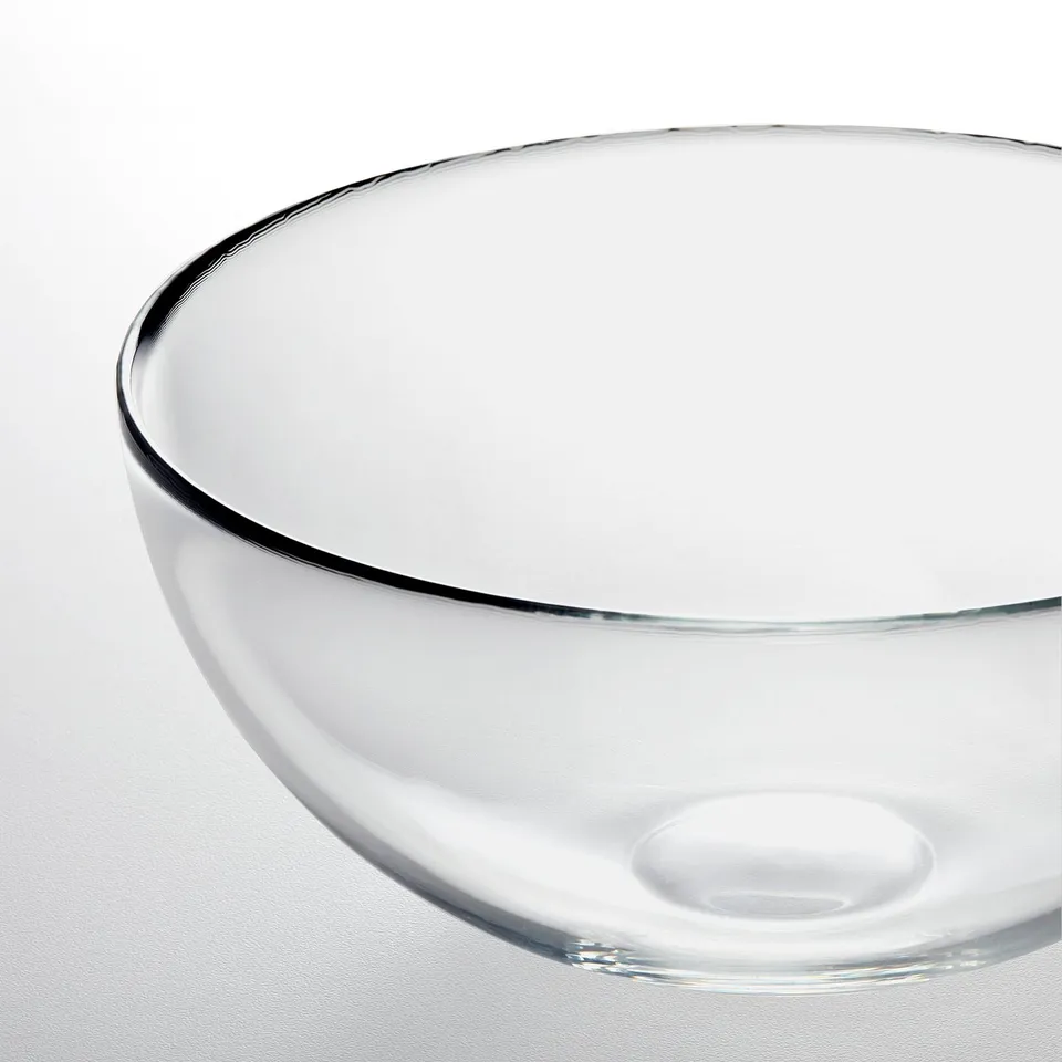 Clear glass bowl on a white surface, showing smooth edges and transparent design.