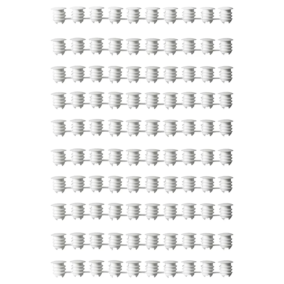Rows of white VARIERA plastic cover caps, cylindrical with ribbed texture, uniformly aligned in a grid.
