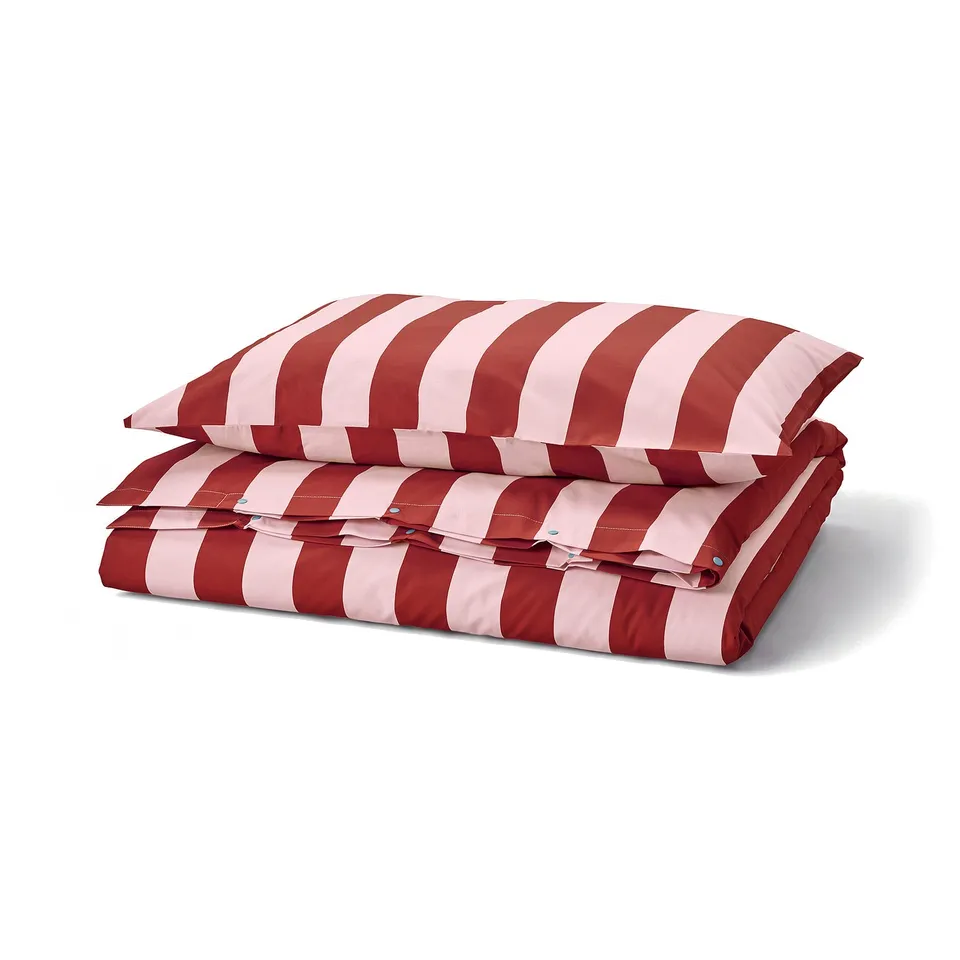 Red and white striped duvet set, folded neatly. Thick, horizontal stripes; made from durable cotton and lyocell blend.