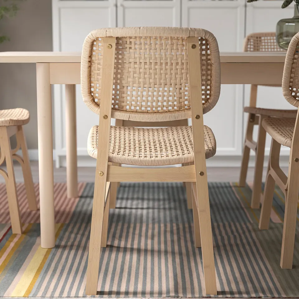 Woven bamboo dining chair, designed for comfort and durability. Angled back and large curved seat for support.