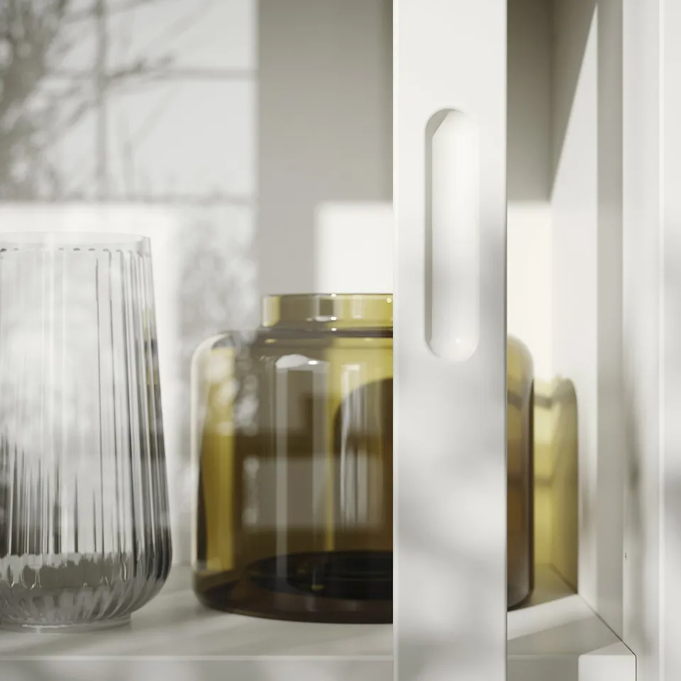 Modern glass-door cabinet with clear ribbed vase and amber round vase, soft-close doors.