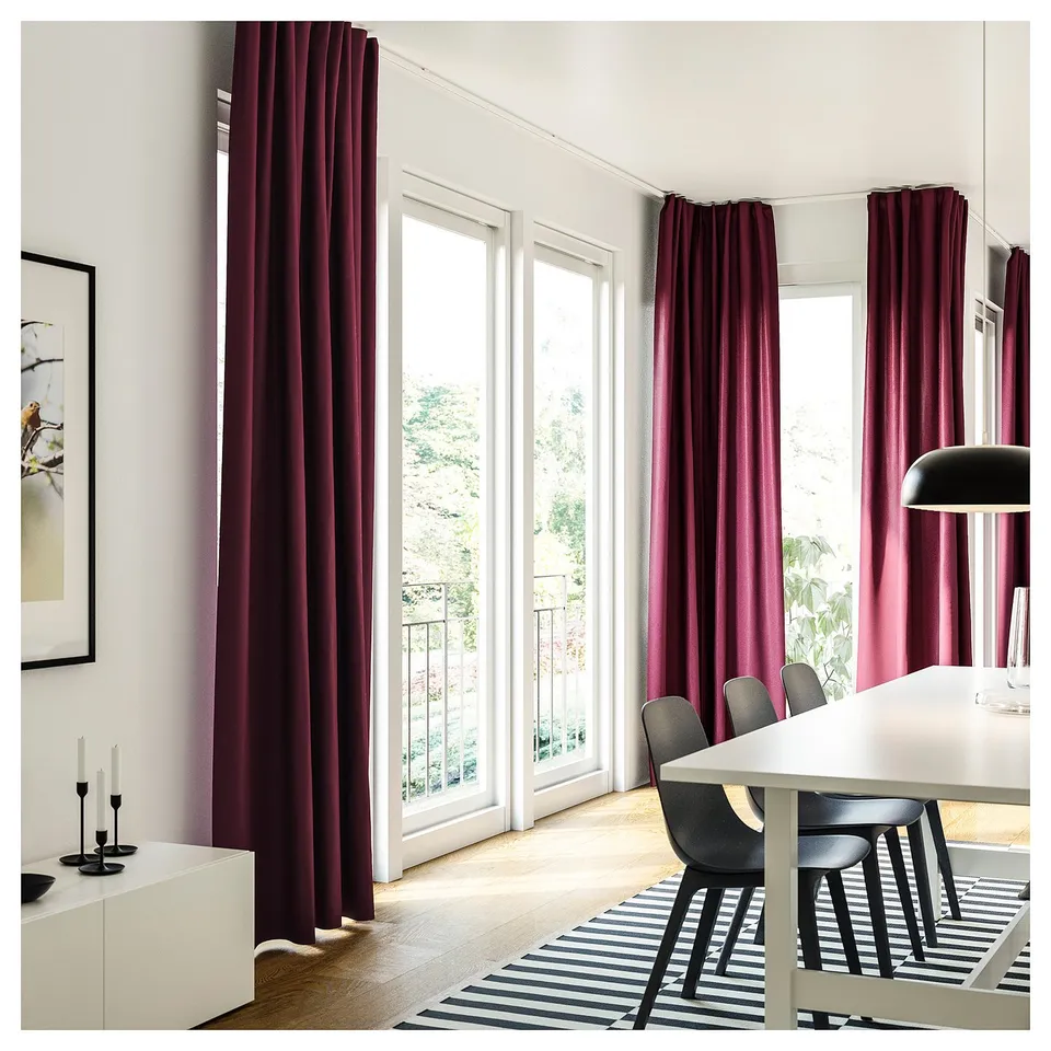 Modern dining area with VIDGA deep red curtains, black chairs, white table, striped rug, and minimalist decor.