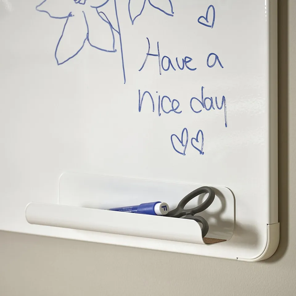 Pen and rubber holder for magnetic board, keeping writing tools handy.