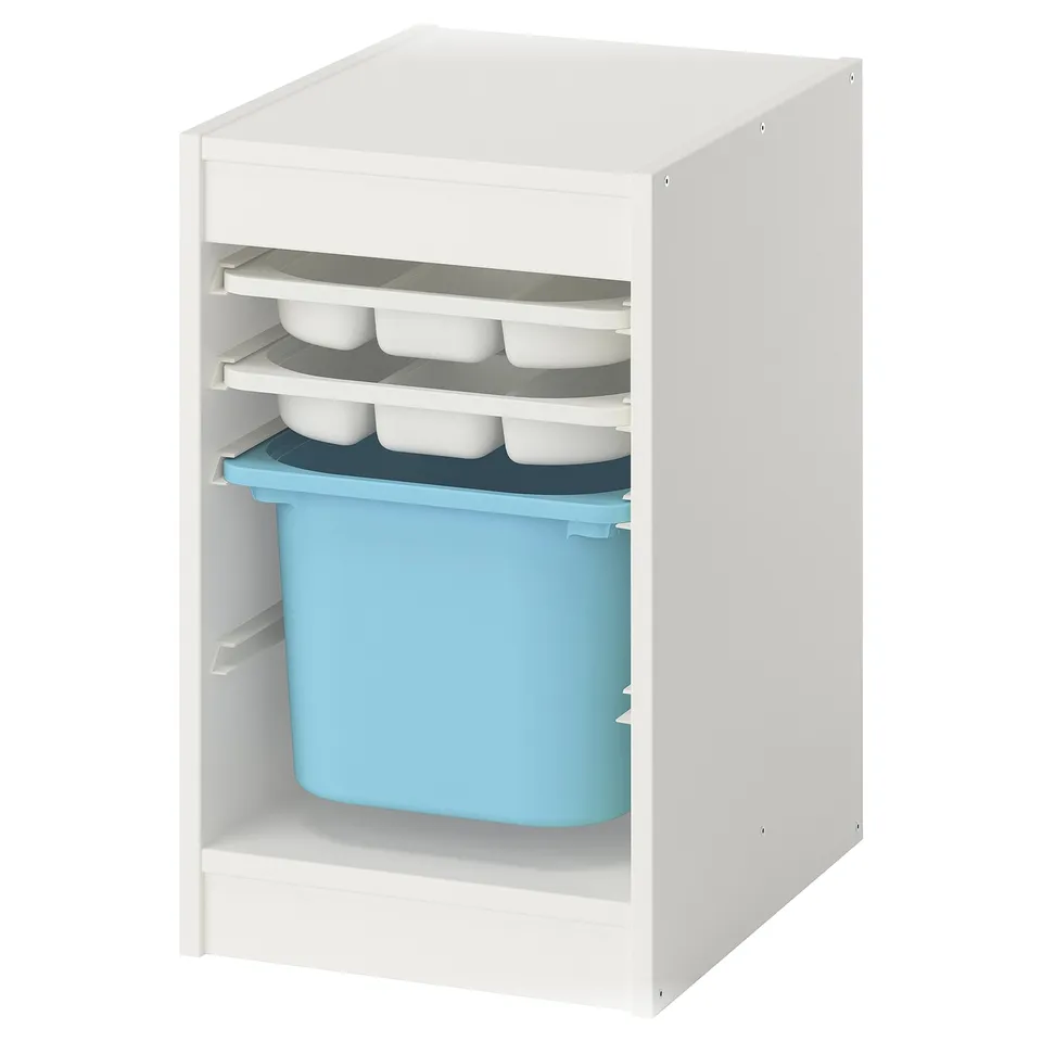 A white TROFAST storage unit with blue plastic bins and white trays on a shelf.