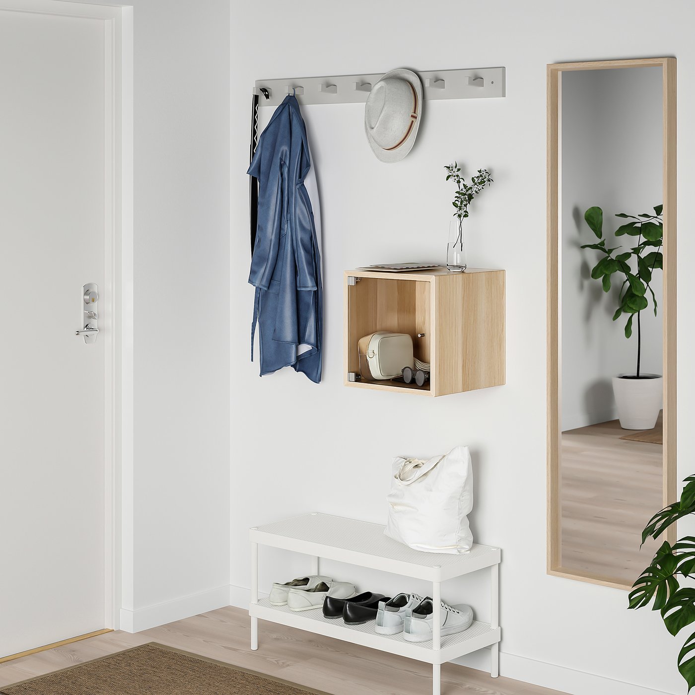 EKET cube storage in entryway with bags, hat, coat rack, and mirror.