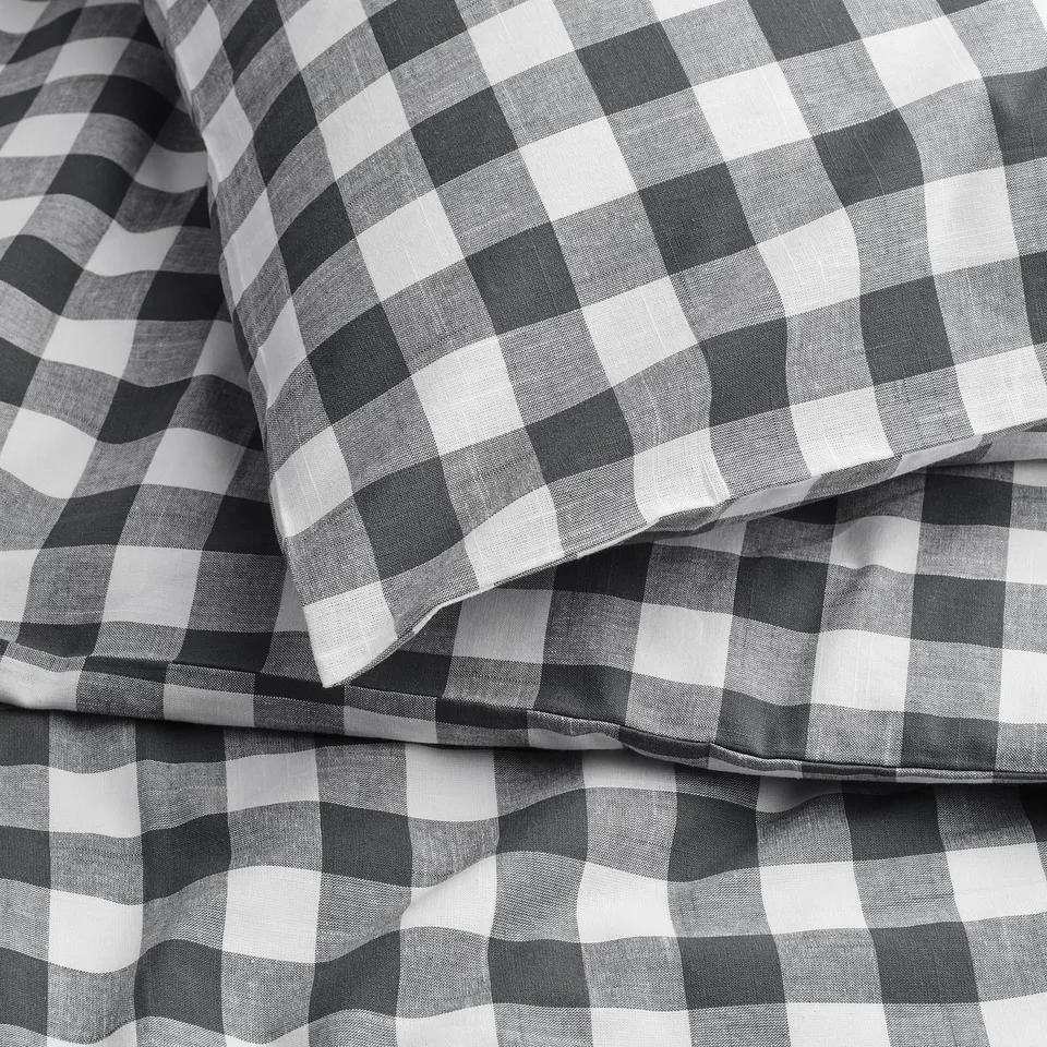 Black and white checked fabric, folded neatly, showcasing quality and pattern.