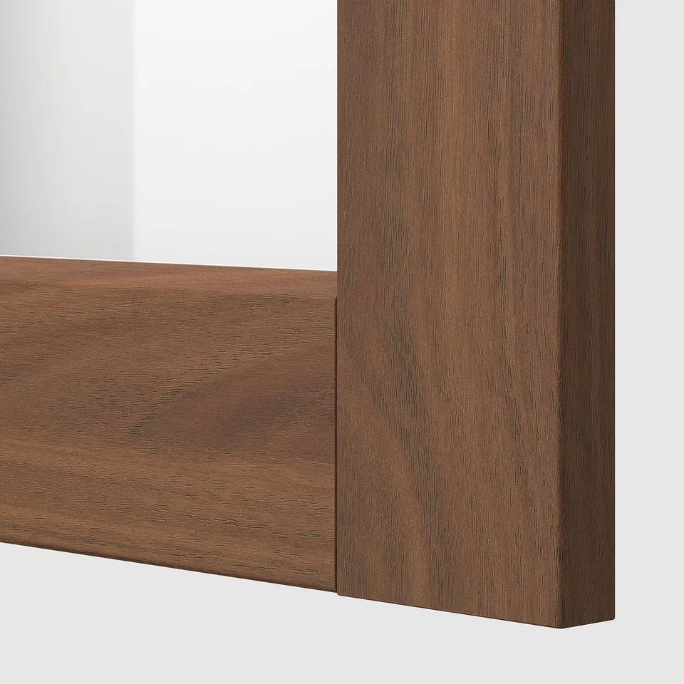 Close-up of a modern, brown wood-like finish kitchen cabinet frame, showing its smooth, sturdy surface and detailed wood grain texture.