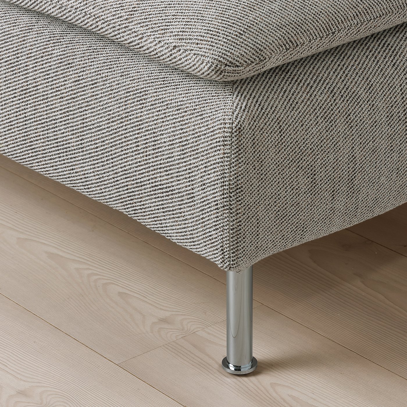 A luxurious, modern sofa with deep seats, high legs, and plush cushions. Its textured, soft fabric invites comfort.
