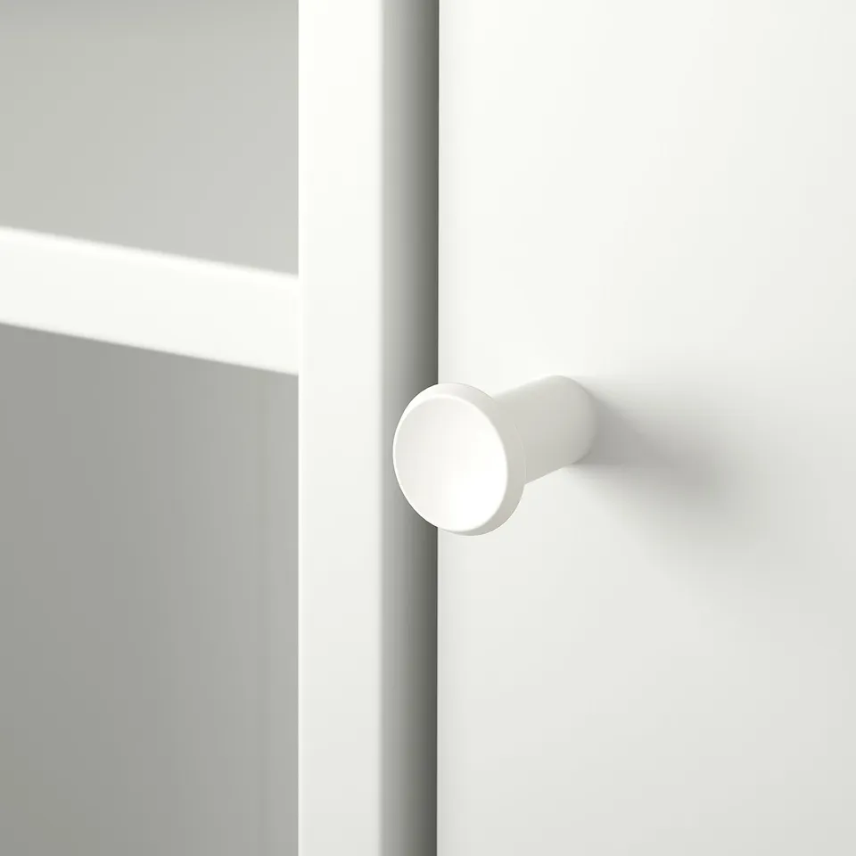 A clean, modern door handle mounted on a smooth white door. Rounded design, high quality finish.