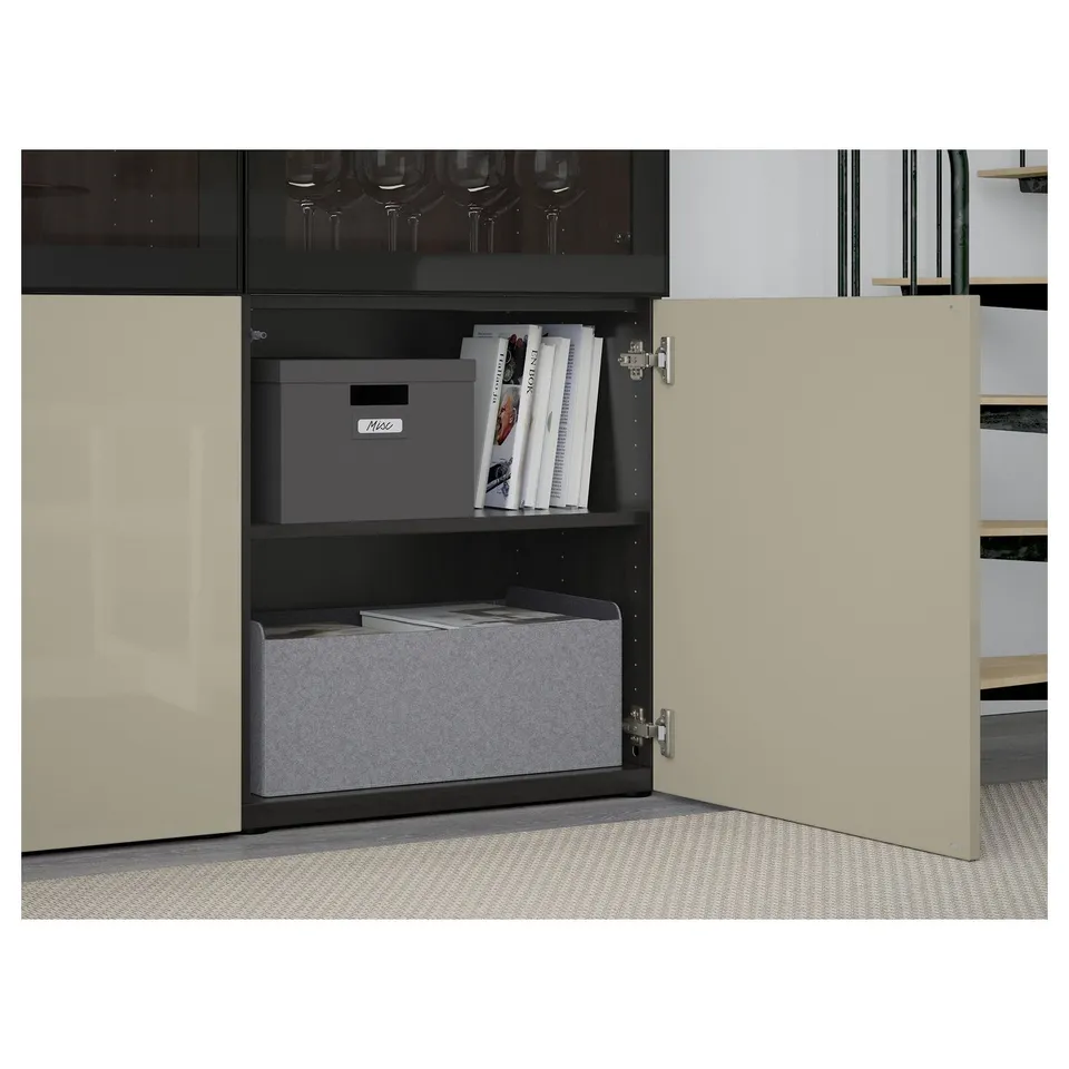 Open BESTÅ cabinet displaying storage boxes and books on shelves, showcasing organised and adjustable interior.
