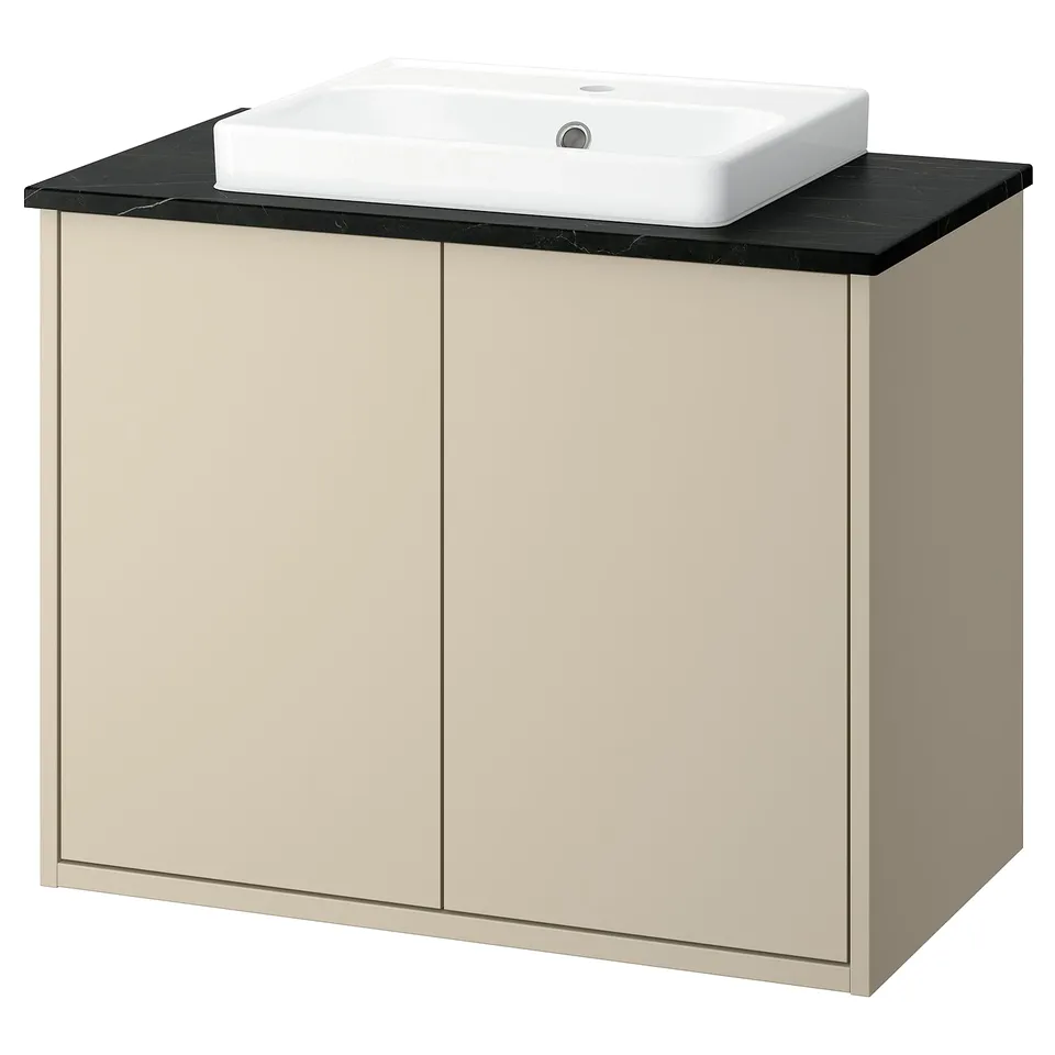 Beige HAVBÄCK bathroom vanity with black marble top, rectangular sink, simple modern design.