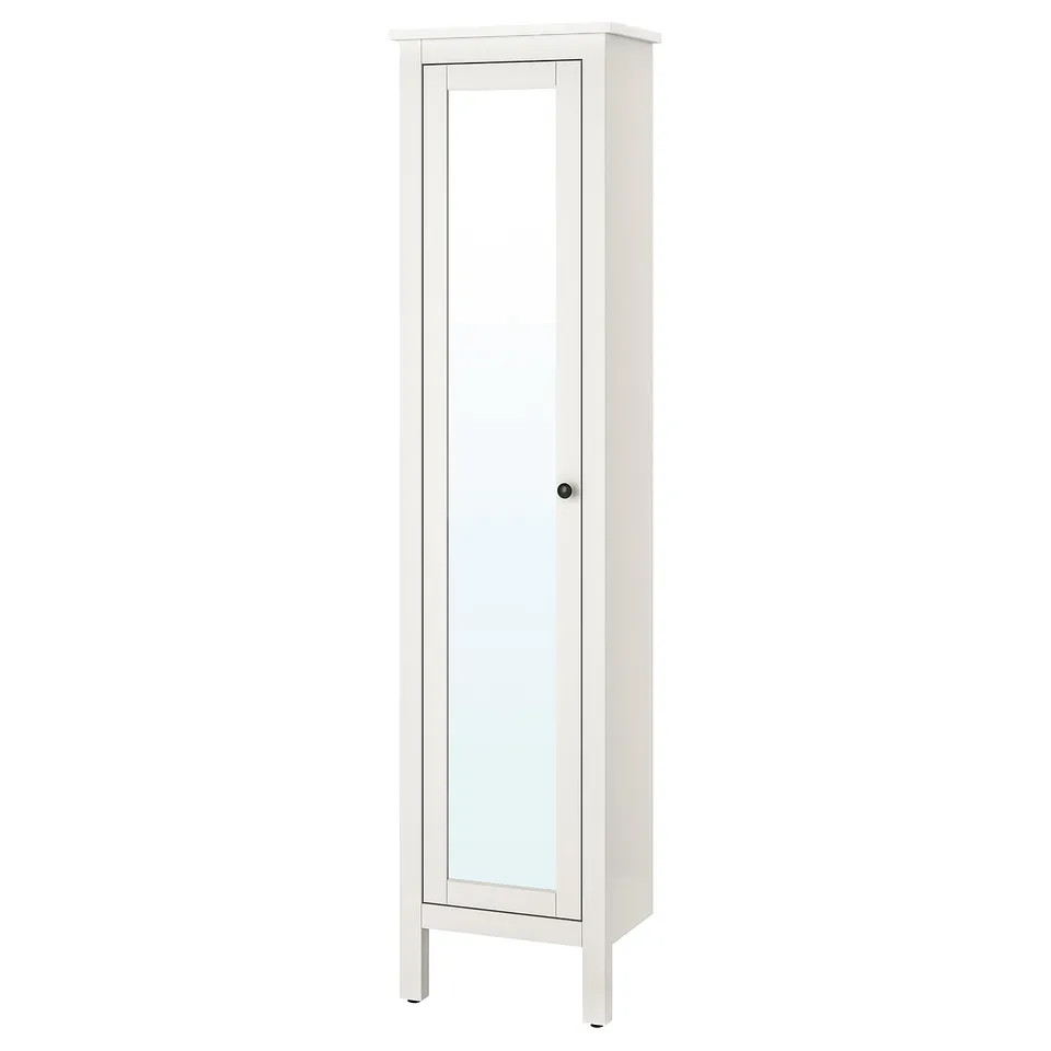 A white HEMNES tall cabinet with a mirrored door. Its rectangular, with a sleek, minimalist design for bathroom storage.