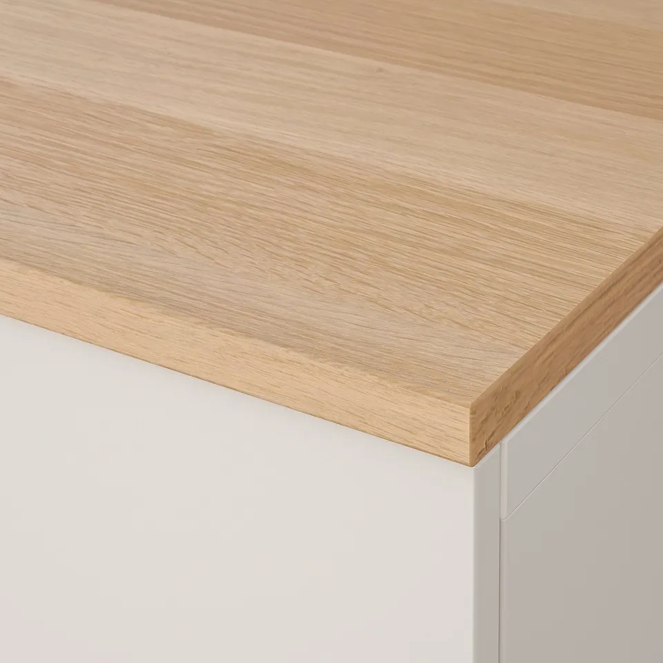 Close-up of sleek, well-crafted wooden countertop. Light honey finish, smooth texture, high-quality appearance.