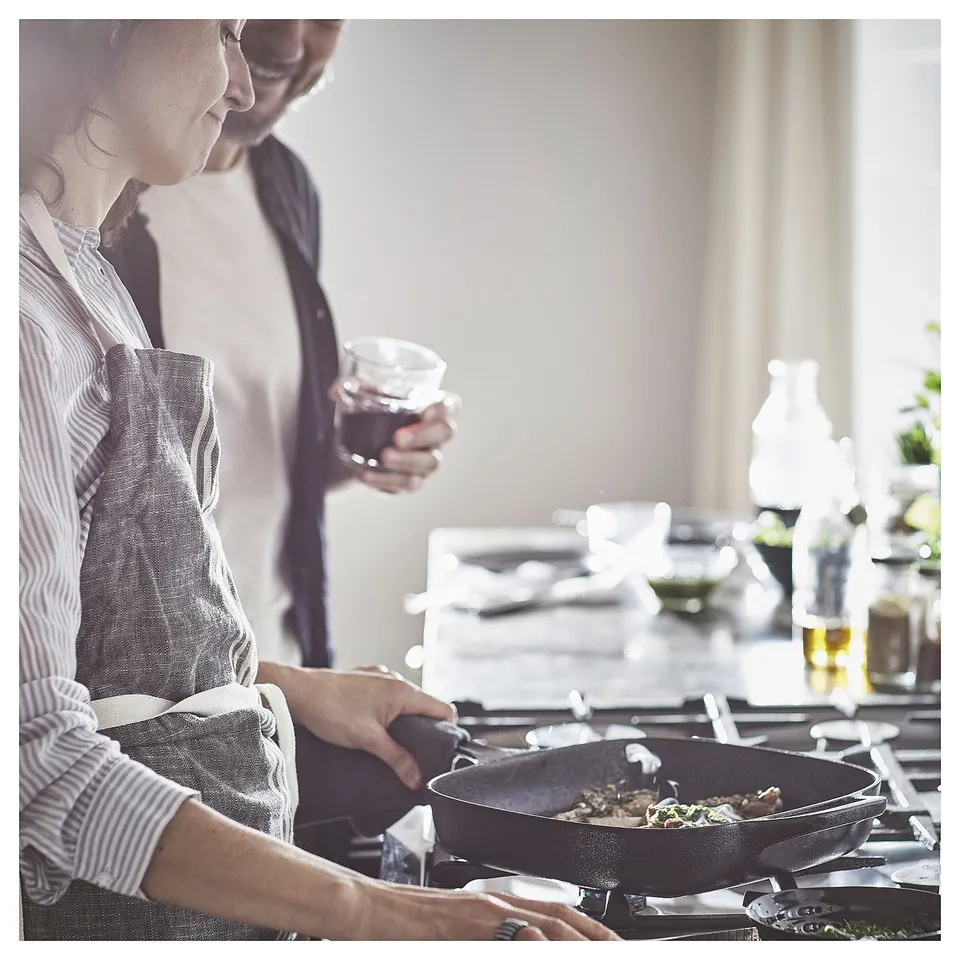 Cooking together with VARDAGEN pan, wine, and plants.