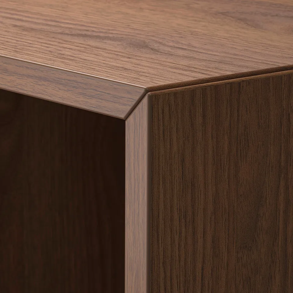 Dark wood-grained BILLY bookcase corner showing fine grain texture and smooth finish.