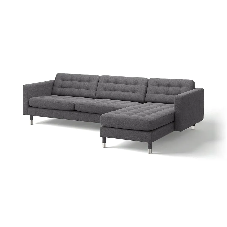 Modern grey l-shaped sofa with tufted seat and back cushions, chrome legs, cosy and contemporary design.