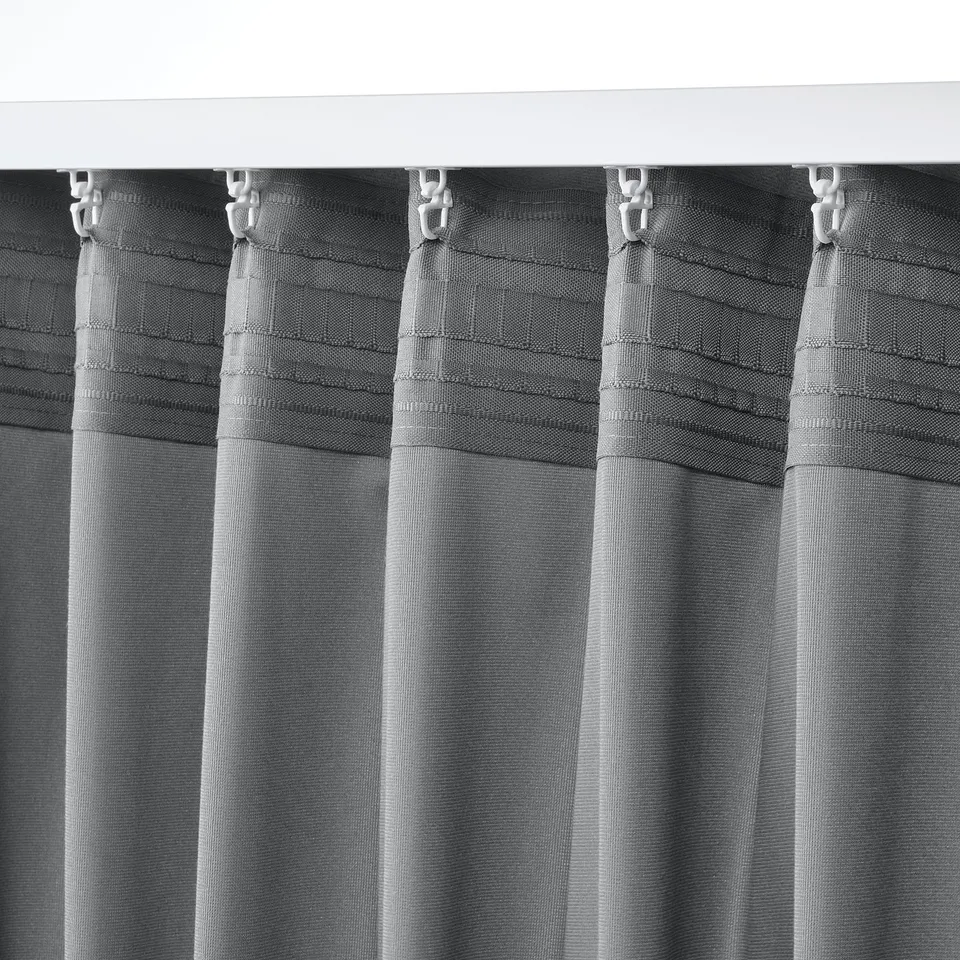 Grey curtains with header hooks for easy hanging, providing privacy with soft, velvet-like texture.