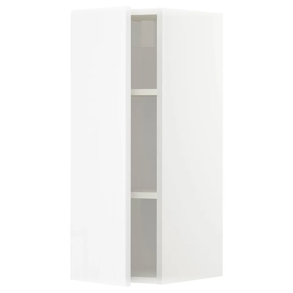 A white, modern corner cabinet. It has three shelves and a sleek, high-gloss finish. The cabinet is part of the METOD kitchen system.