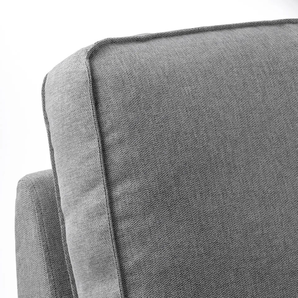 Close-up of KIVIK sofas plush, textured grey fabric, showcasing its high-quality, comfortable, and durable design.