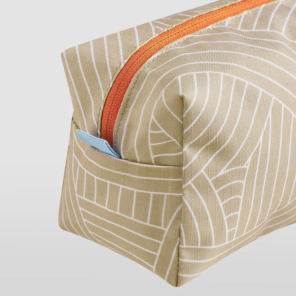 Recycled polyester zip pouch; intricate beige and white pattern; orange and blue accents.