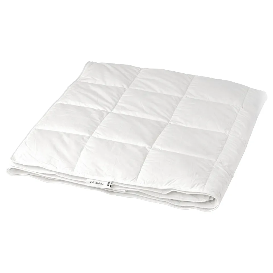 A white fjällräckka duvet, rectangular in shape, filled with recycled down and feathers for light warmth. It a box-stitch pattern for breathability.
