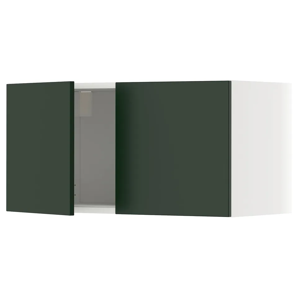A green METOD kitchen cabinet with a white door open, revealing the interior.