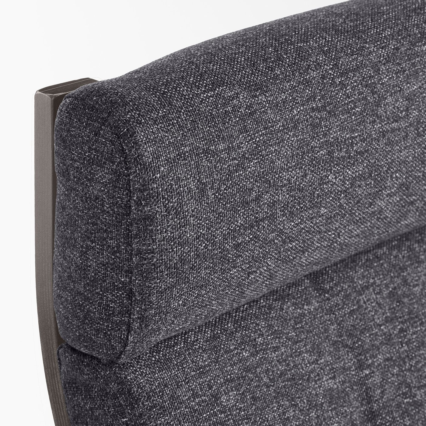 A close-up of a high-quality, plush armchair cushion with tufted detail and support fabric, highlighting its comfort and resilience.