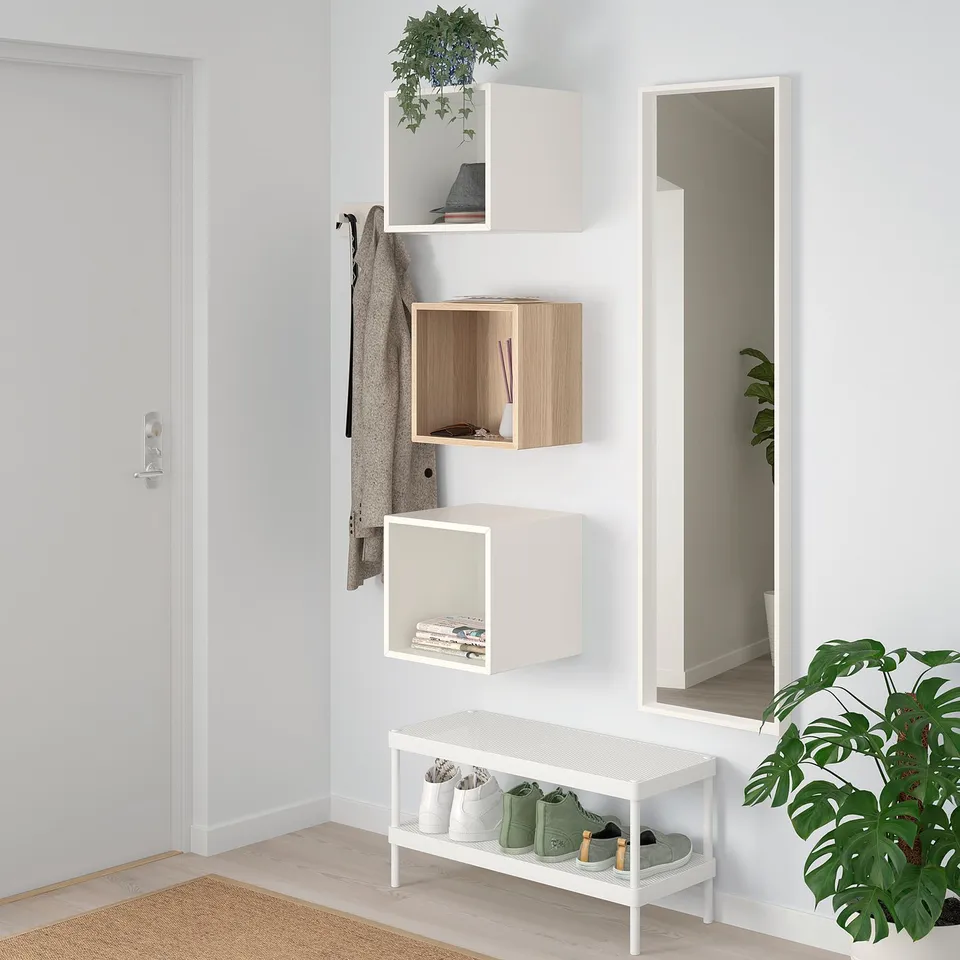 White & wood EKET cabinets with bench & mirror. Plant beside.