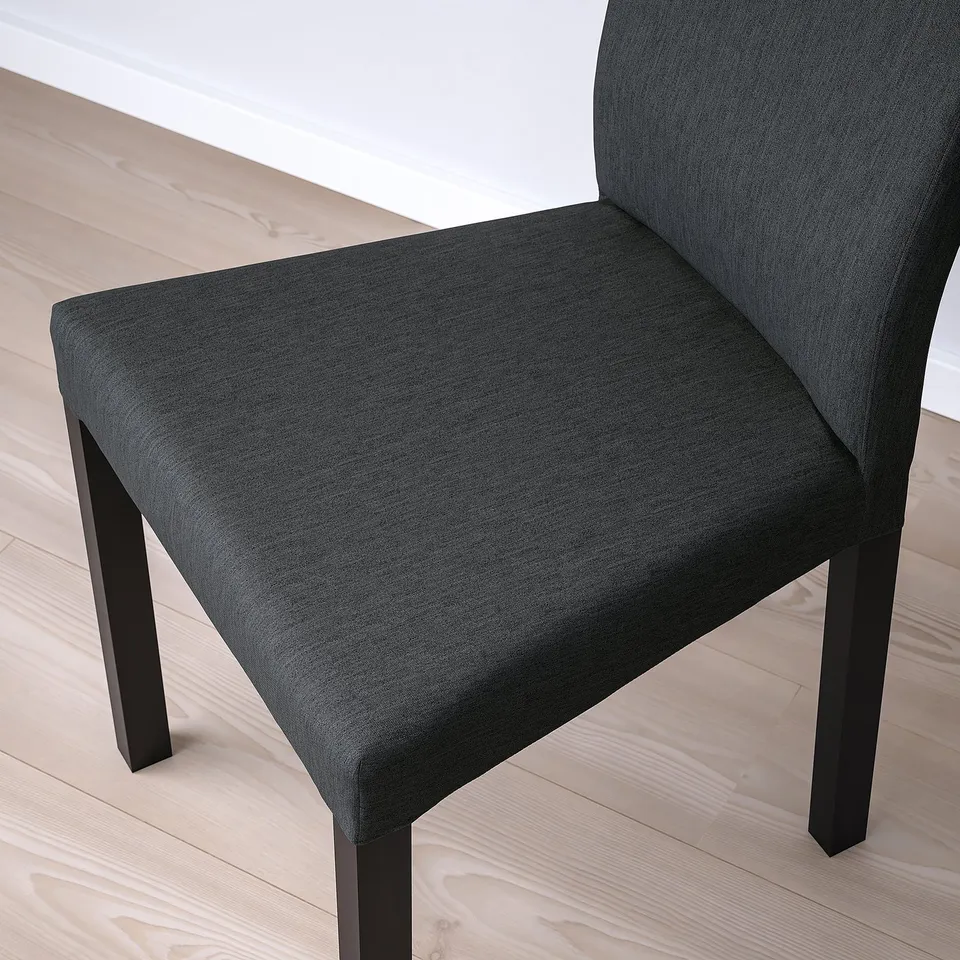 Modern dark grey fabric dining chair with cushioned seat and back, on light wooden floor.