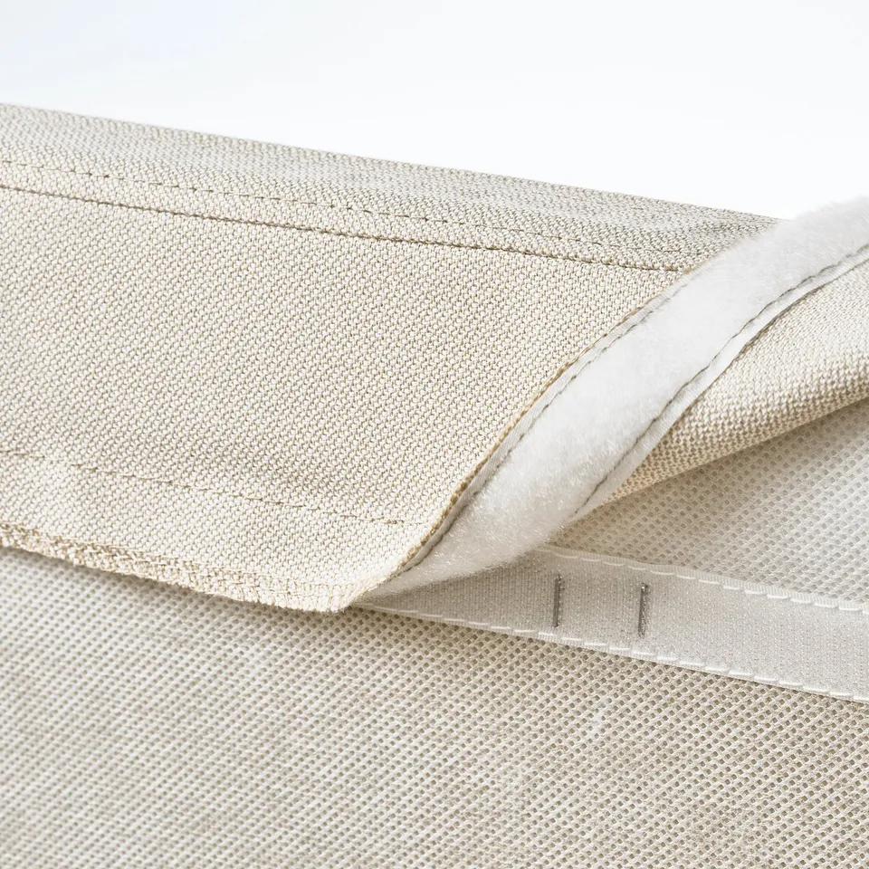 Beige upholstered bed with removable, washable cover and cushioned headboard.