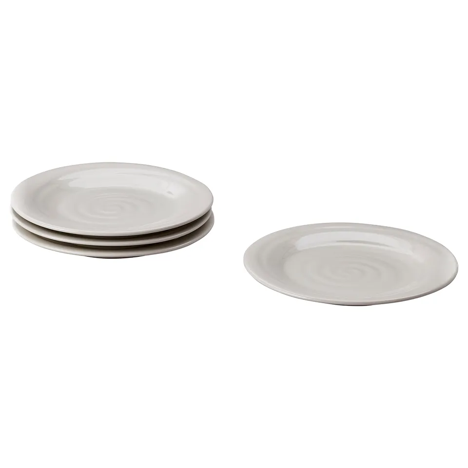 Four white ceramic plates with a rustic swirl pattern, stacked in two groups.