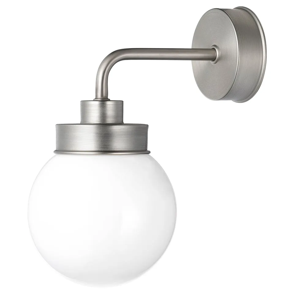 A FRIHULT silver wall lamp with a round glass shade.