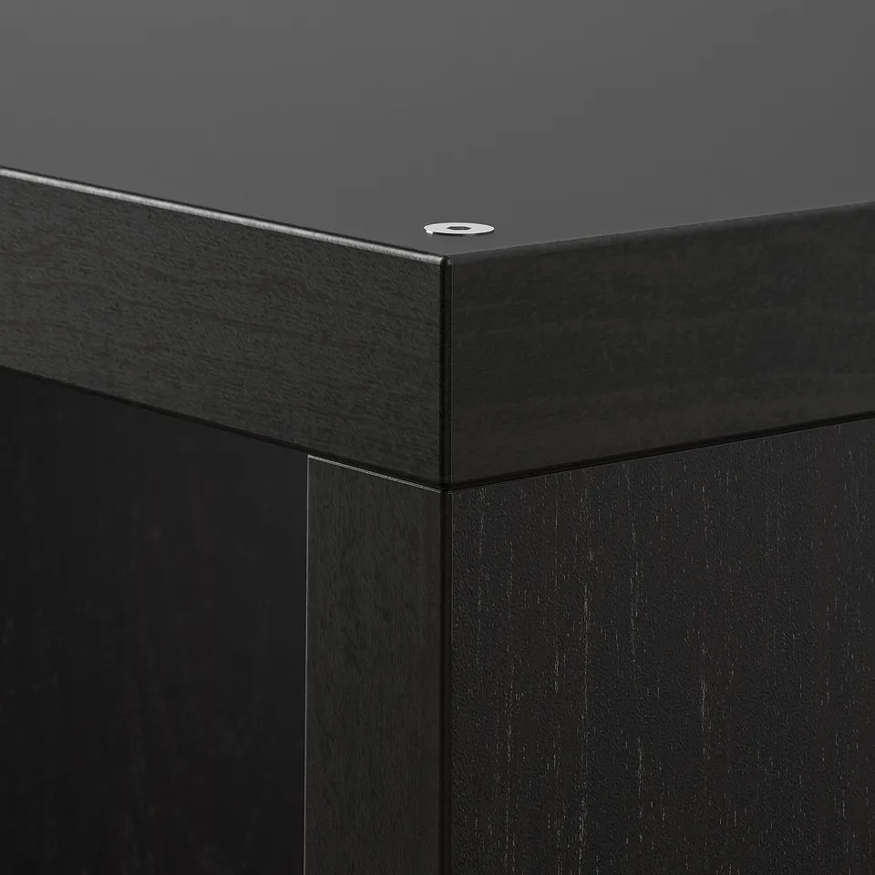 Black KALLAX shelf unit corner, smooth finish, sturdy build.