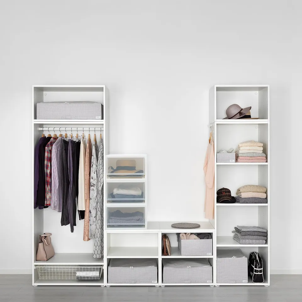 Modern closet with hangers, shelves, and drawers for neat clothing storage.