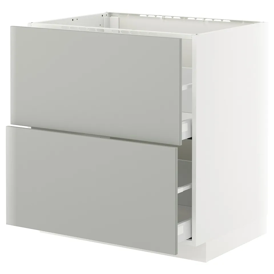A white METOD kitchen cabinet with light grey drawers and a modern design.