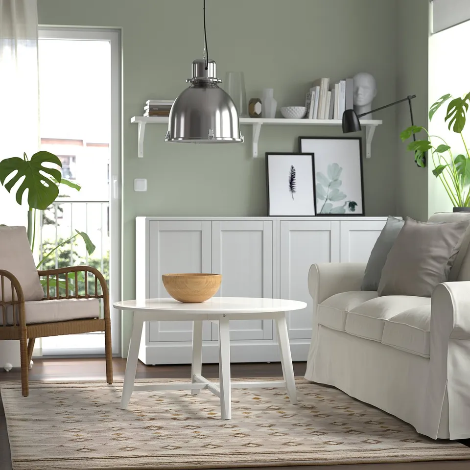 Modern living room with white VÄGNÄT rug, grey couch, and round table.