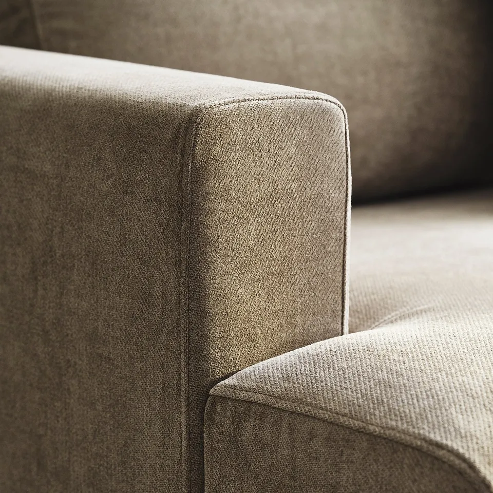 Close-up of plush, stylish sofa showing its soft, textured fabric and comfortable, inviting cushions.