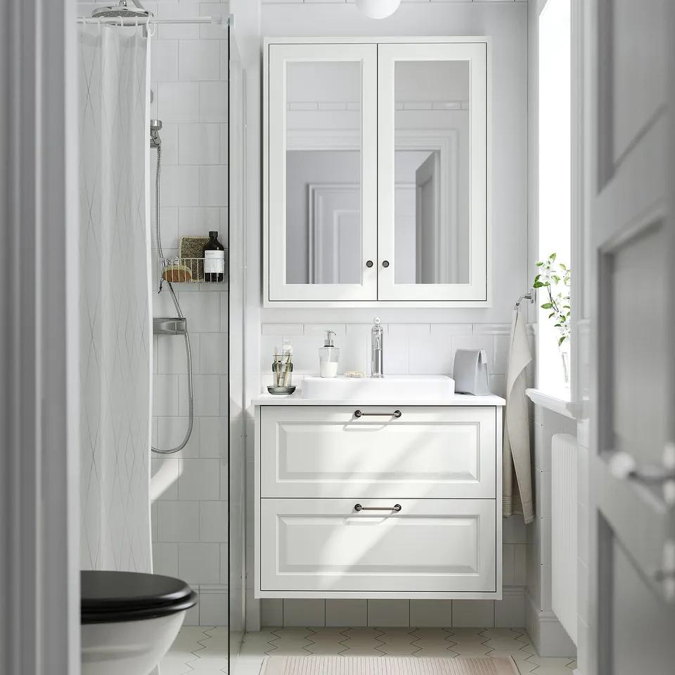 Semi-recessed sink, 2-drawer cabinet, mirror, shower curtain, towel rack - classic, elegant, space-efficient bathroom.