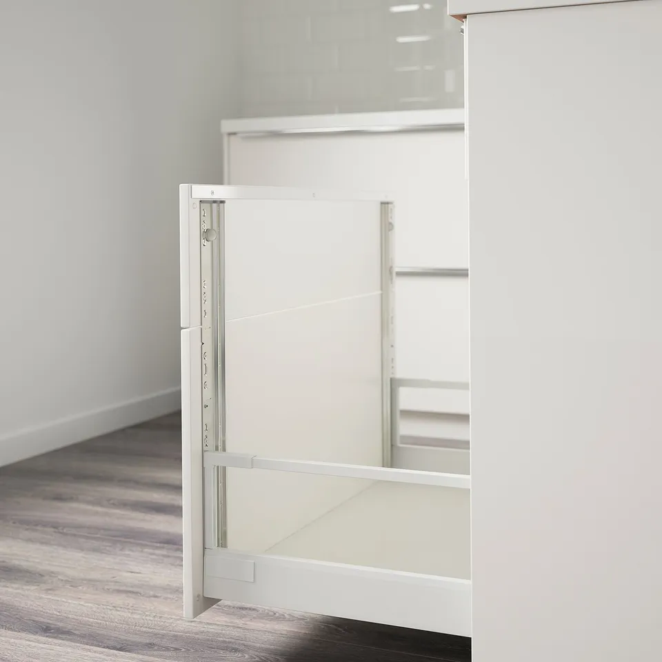 Close-up of a UTRUSTA rail, connects drawer fronts to match cabinet faces, with screws included.