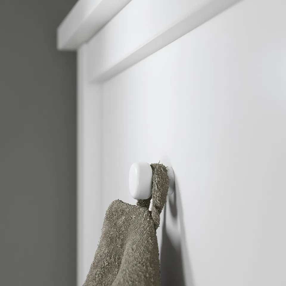 White robe on hook, clean bathroom.